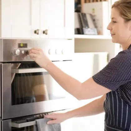 woman operating wall oven